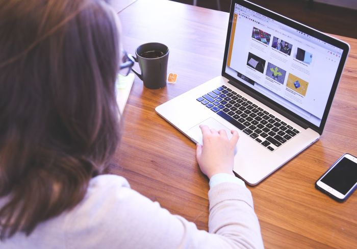 woman using technology browsing on a computer