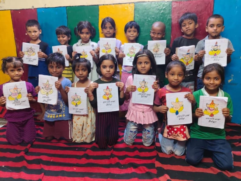 Children at Mera Sahara Centre in Noida holding their Ganesha drawings