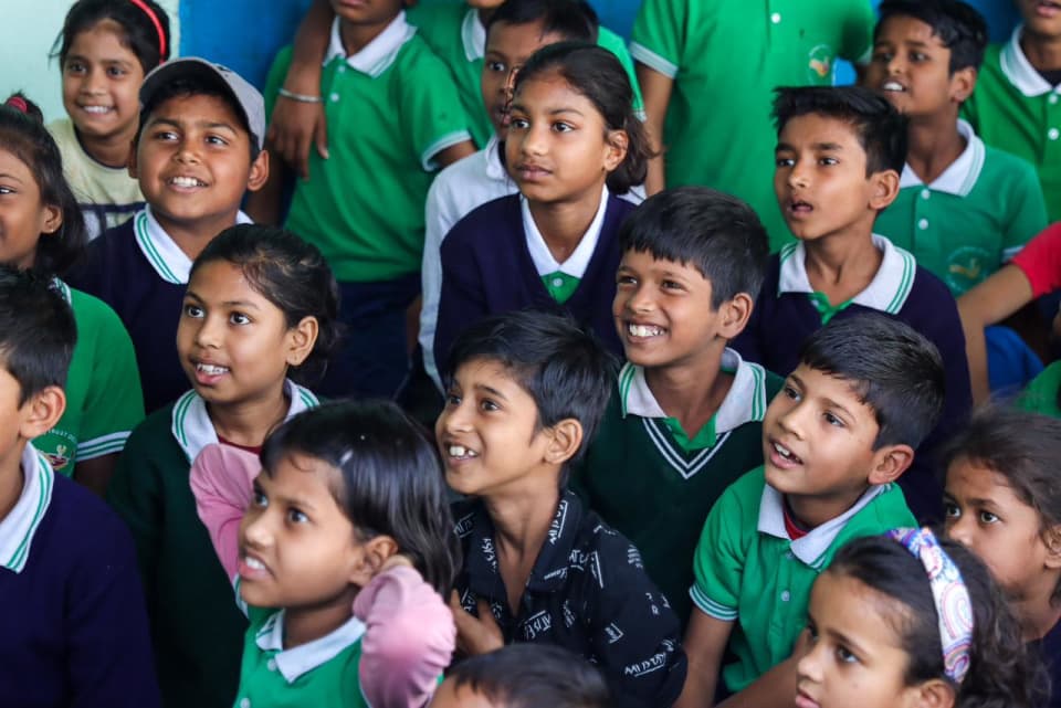 Schoolchildren smiling together in class