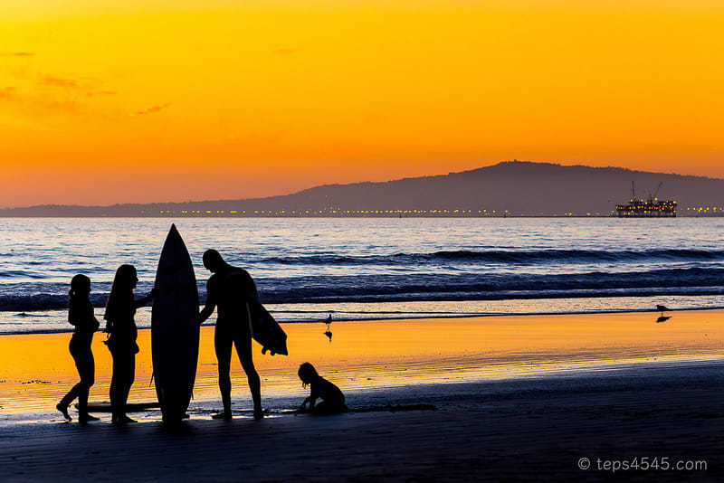 Surfer family on sunset