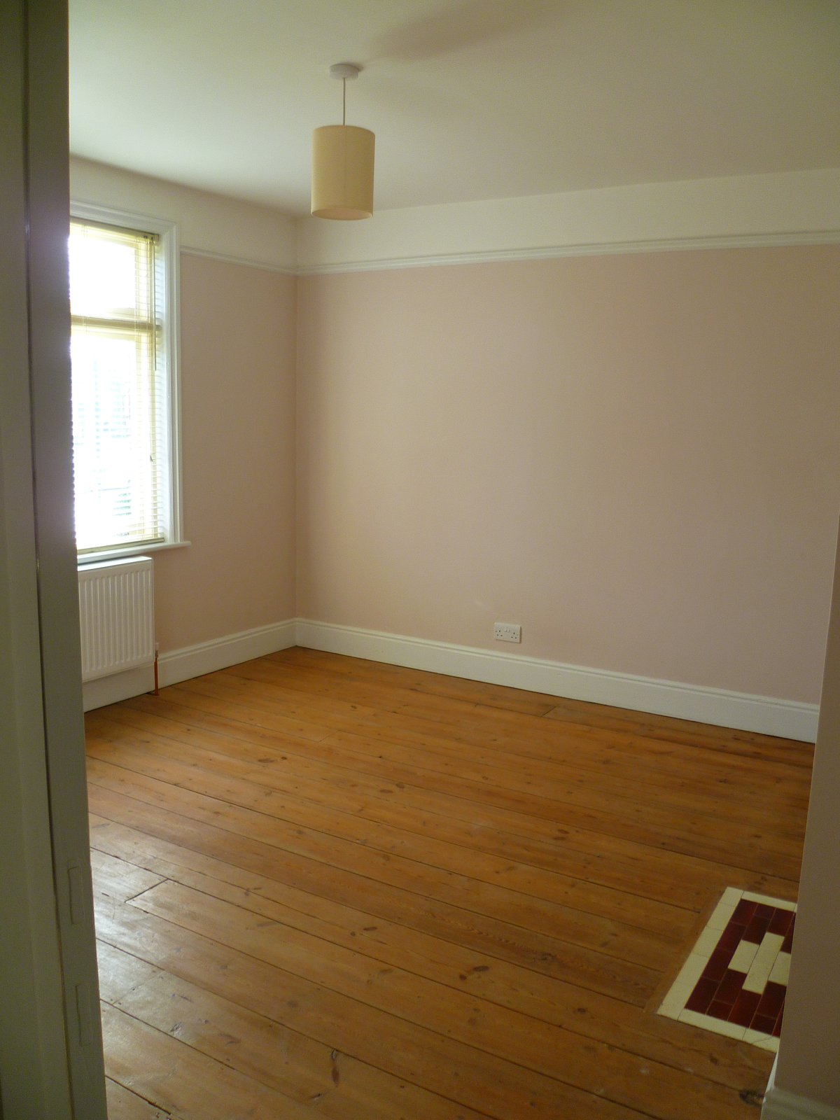 An image showing restoration work for the back bedroom including floor sanding and refinishing, plastering, and painting and decorating