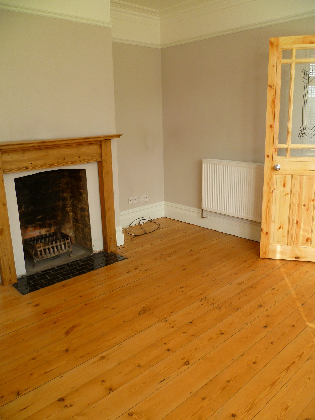 An image showing restoration work for the back bedroom including floor sanding and refinishing, plastering, and painting and decorating