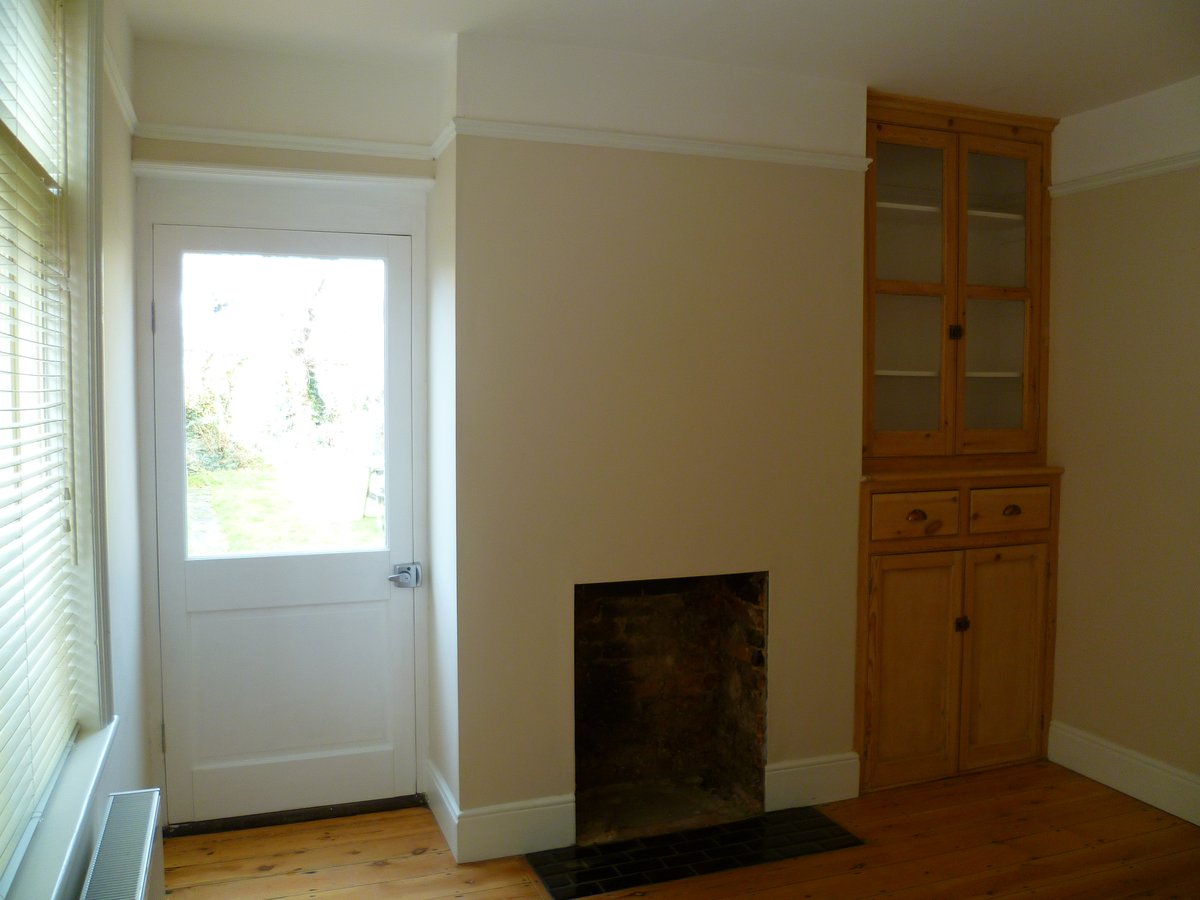 An image showing restoration work for the back bedroom including floor sanding and refinishing, plastering, and painting and decorating