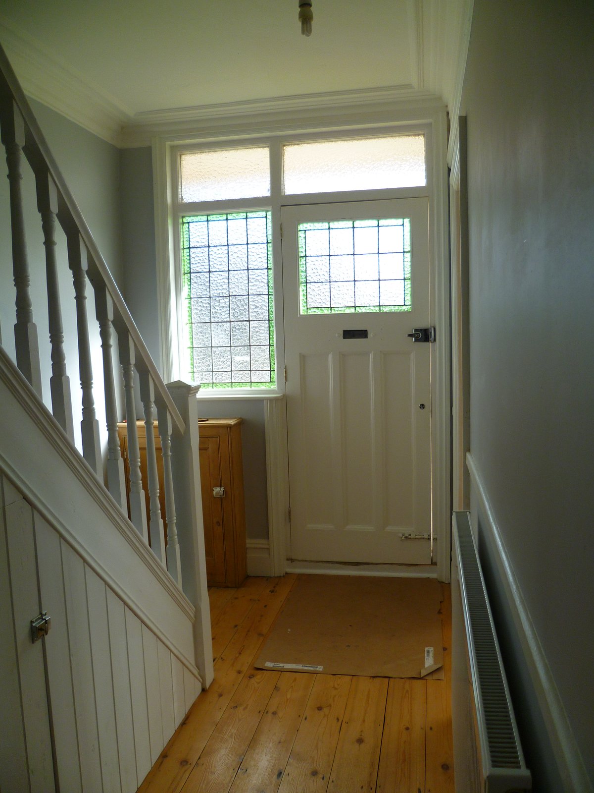 An image showing restoration work for the back bedroom including floor sanding and refinishing, plastering, and painting and decorating