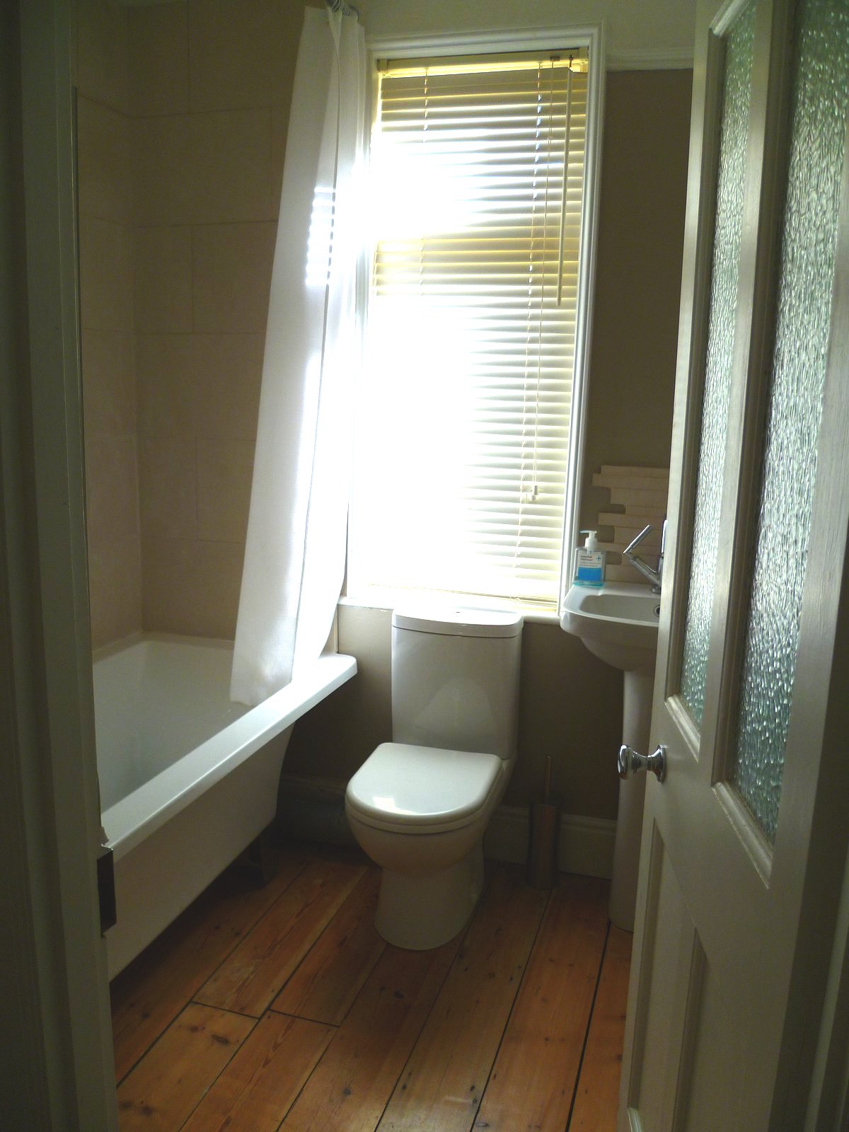 An image showing restoration work for the back bedroom including floor sanding and refinishing, plastering, and painting and decorating