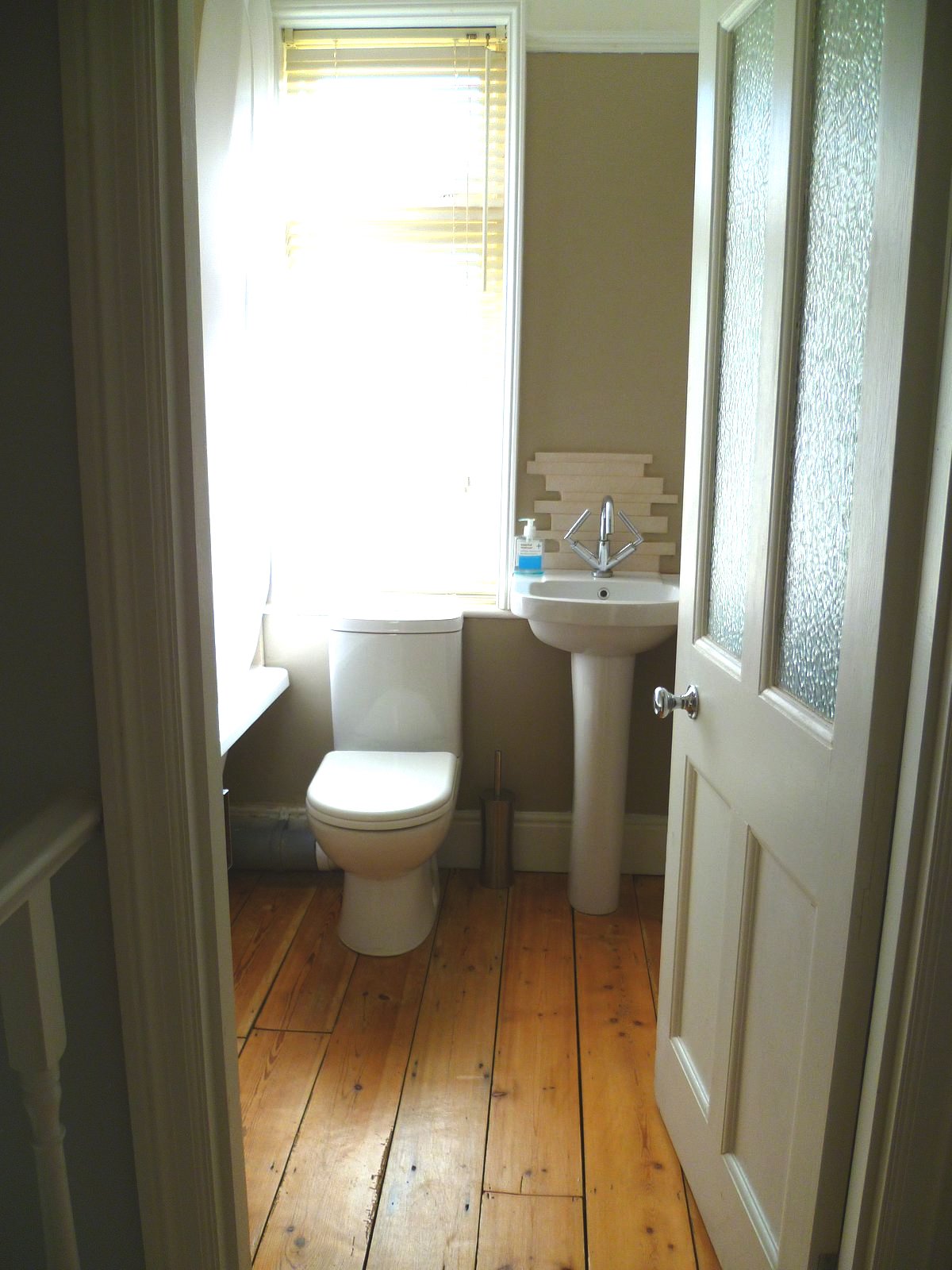 An image showing restoration work for the back bedroom including floor sanding and refinishing, plastering, and painting and decorating