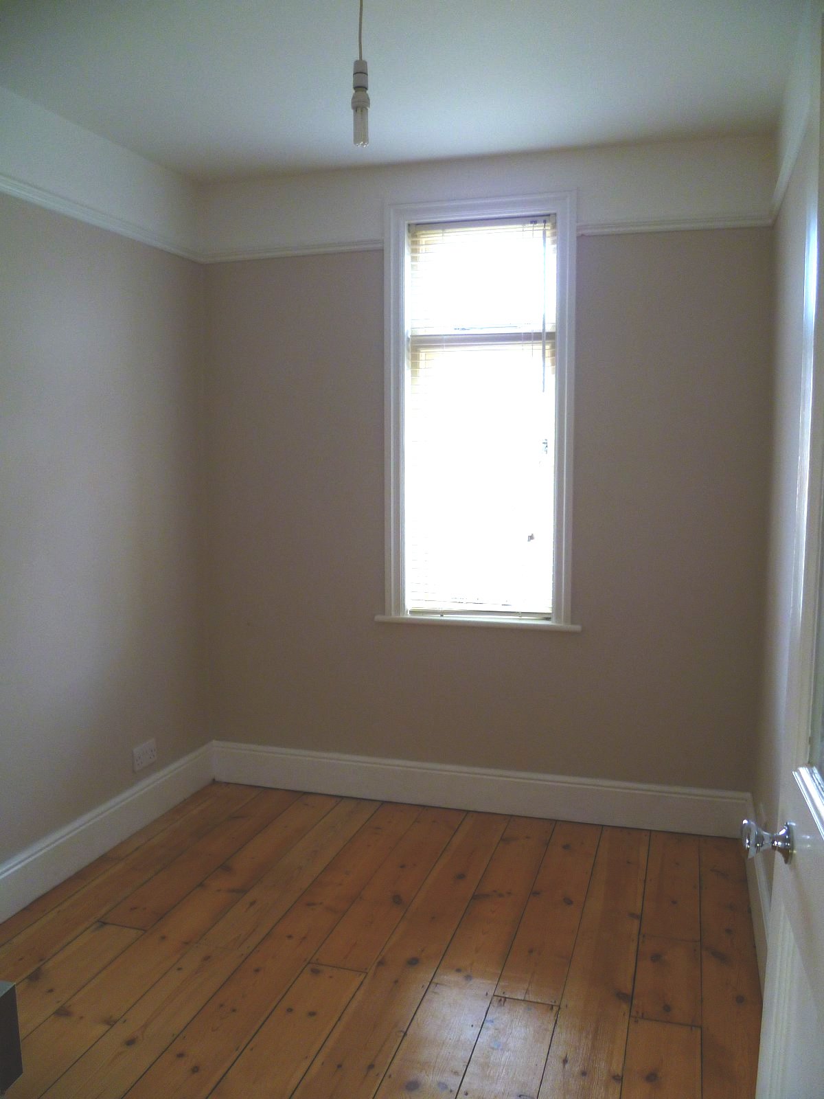 An image showing restoration work for the back bedroom including floor sanding and refinishing, plastering, and painting and decorating
