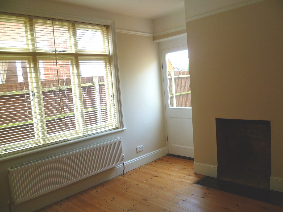 An image showing restoration work for the back bedroom including floor sanding and refinishing, plastering, and painting and decorating