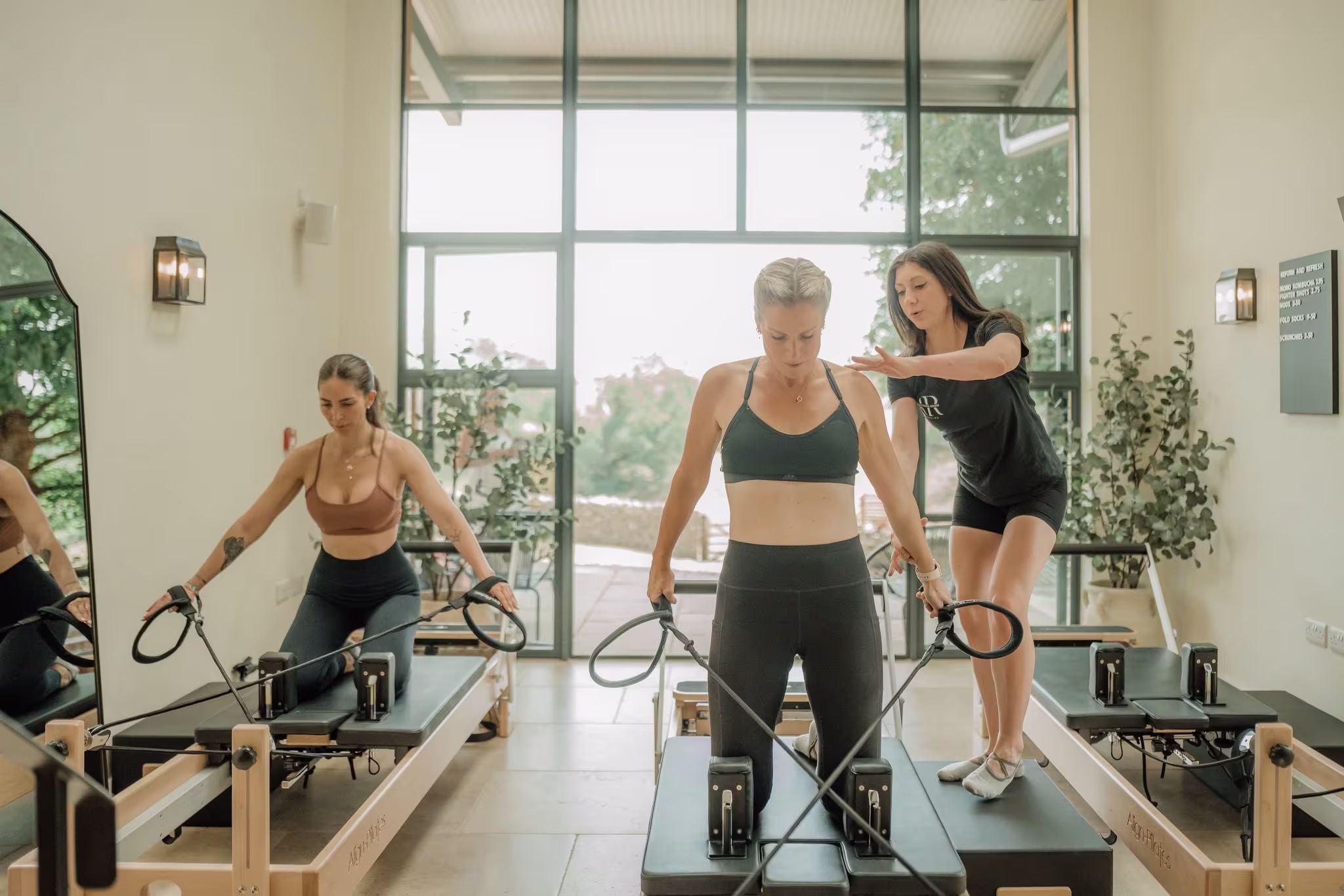 Reformer Pilates class inside the studio with instructor