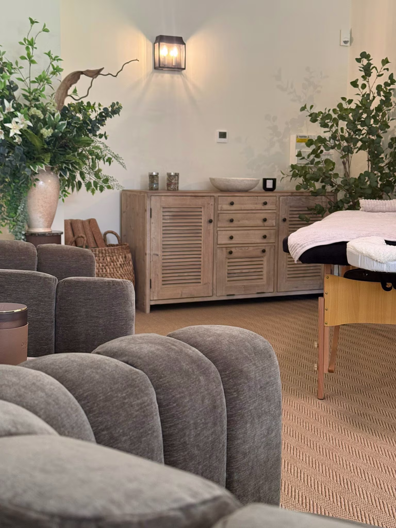 Inside the the retreat room with massage table and comfy seating