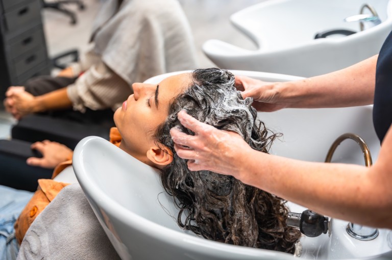 Hair spa treatment in Gurgaon with professional stylist washing and nourishing hair at a salon