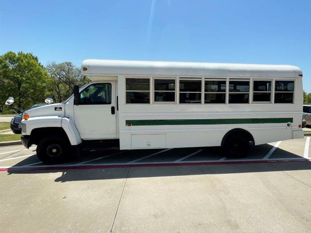 Used Bus Side view, passenger side with doors open