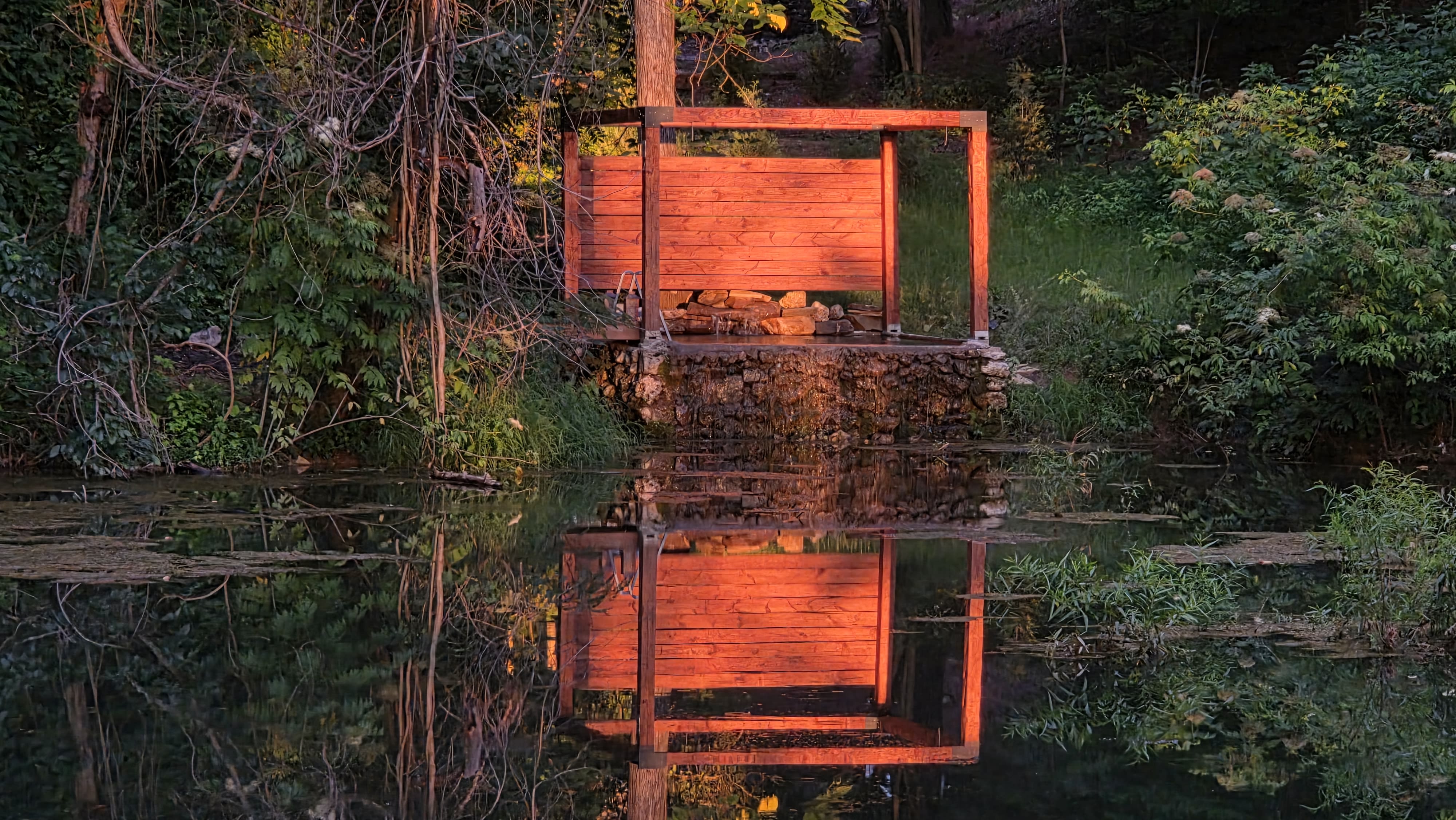 The pergola and spring-fed plunge pool at twilight