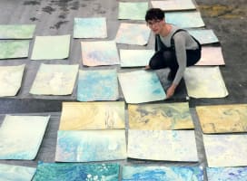 Woman with marbled paper spread out on the floor