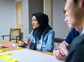 Two young people talking and participating in a workshop