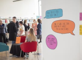 People talking to each other during an art exhibition in a library