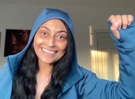 A person smiling with fist up celebrating a win