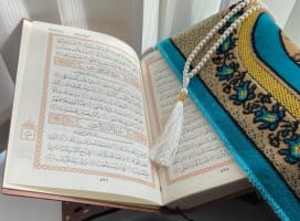 Prayer book open to page with hand writing in