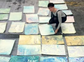 Woman with marbled paper spread out on the floor
