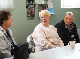 3 people sat talking to eachother