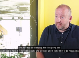 Mark talks in front of a camera