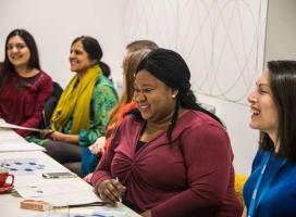 A group of people laughing around a table