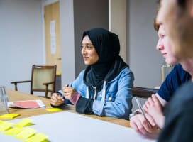Two young people talking and participating in a workshop