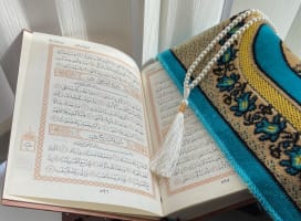 Prayer book open to page with hand writing in