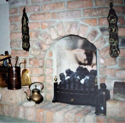 Brick layered fireplace with decorative objects around