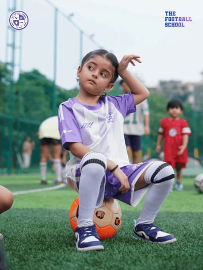 Children learning ball control at football academy in Noida