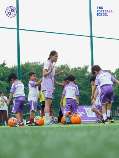 AFC licensed coach teaching dribbling to young players at The Football School Noida