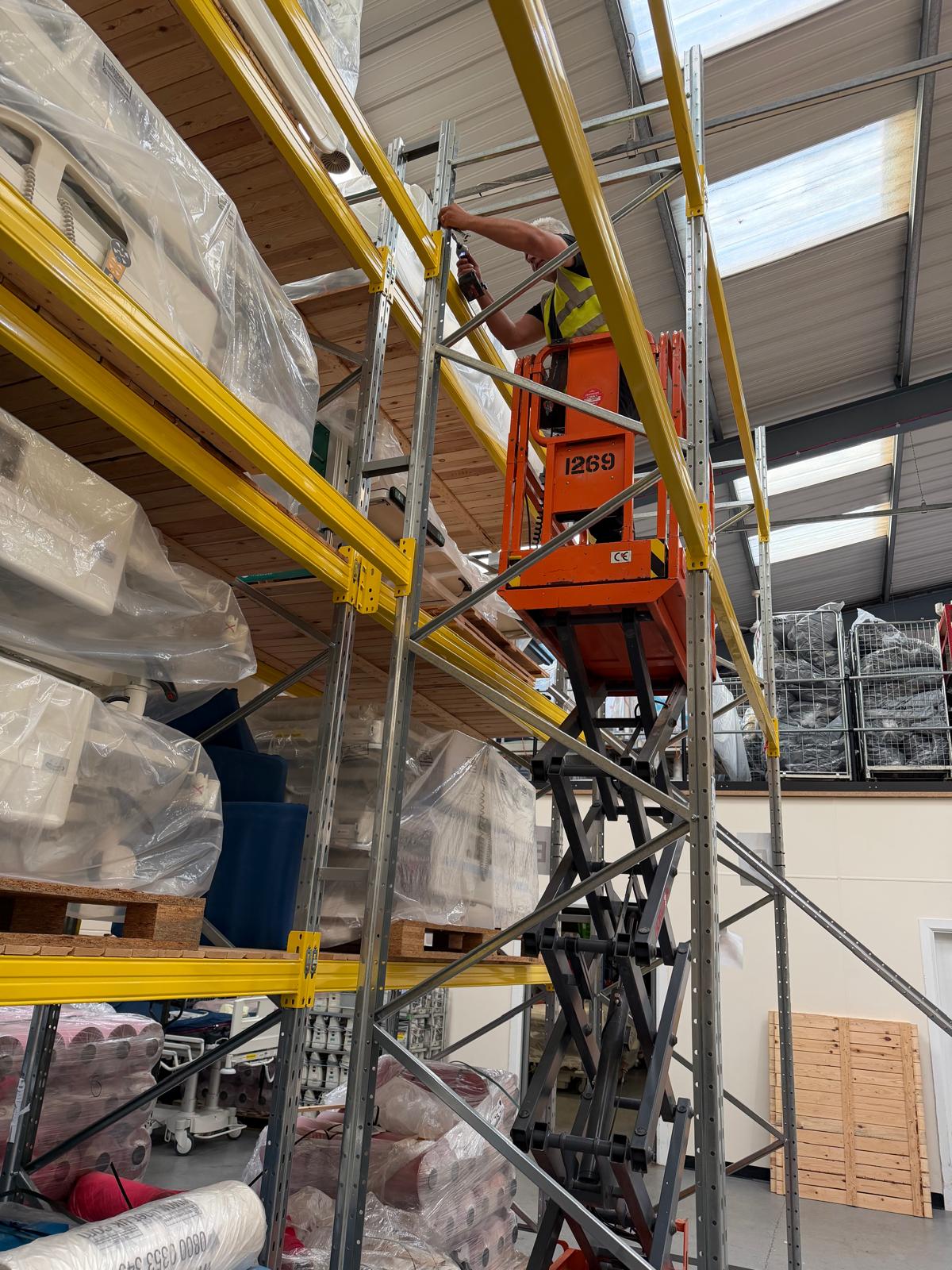 Damaged yellow load beam hand-labelled 'DAMAGED DO NOT USE' identified during emergency diagnosis