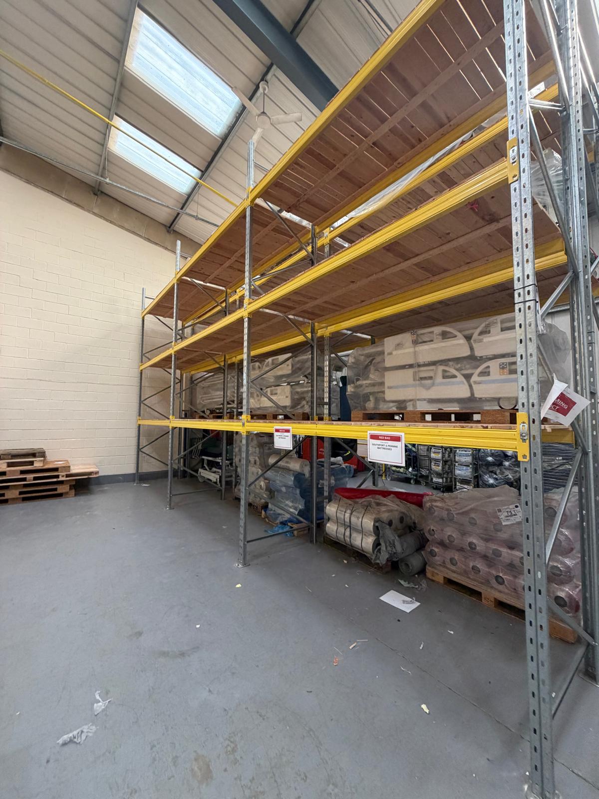 Damaged timber decking panel hand-labelled 'DAMAGED DO NOT USE' after forklift impact at the Wigan healthcare distribution facility