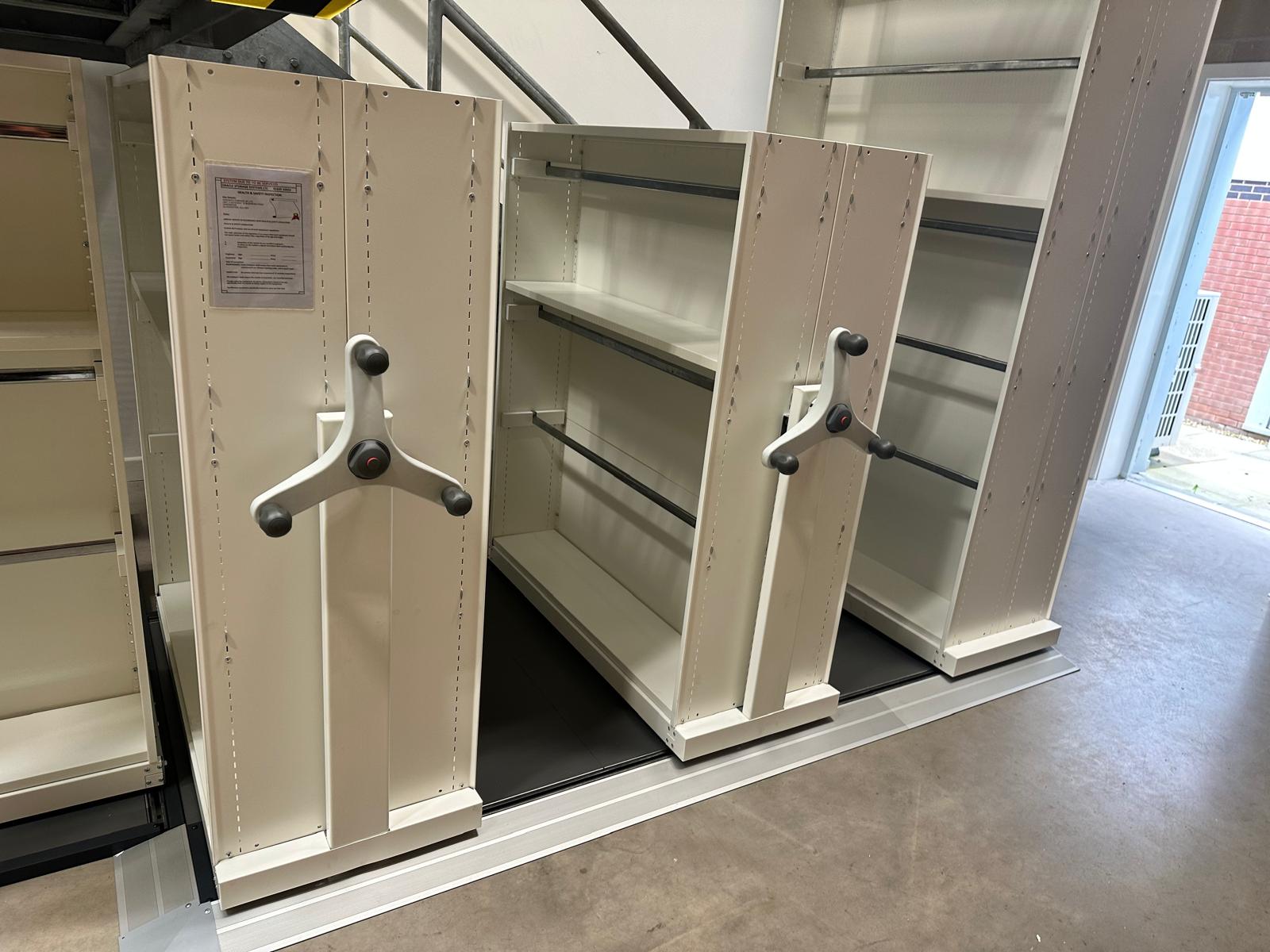 Assembled mobile shelving units beneath the staircase
