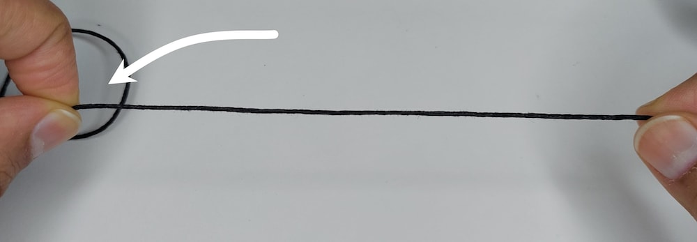 Step 1c: pinch the string at are of overlap