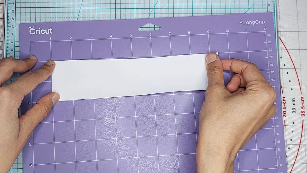 Step 2: Apply the transfer tape to your mat Step 2: I apply the transfer tape to my mat with the white solid backing facing upwards.