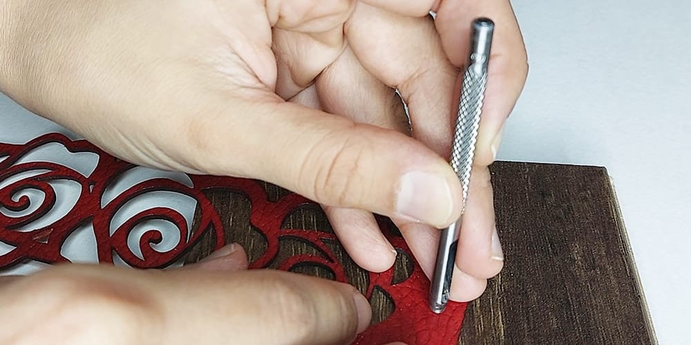 Aligning hole punching tool Shows alignment of hole punching tool on the leather