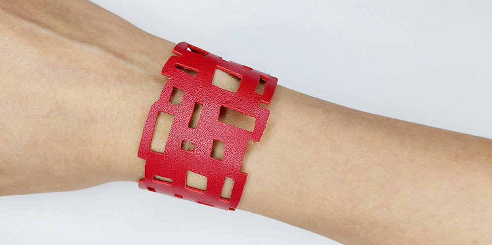 Cricut leather bracelet 9 Cricut leather bracelet 9 that is in a smooth red leather with a geometric rectangle pattern.
