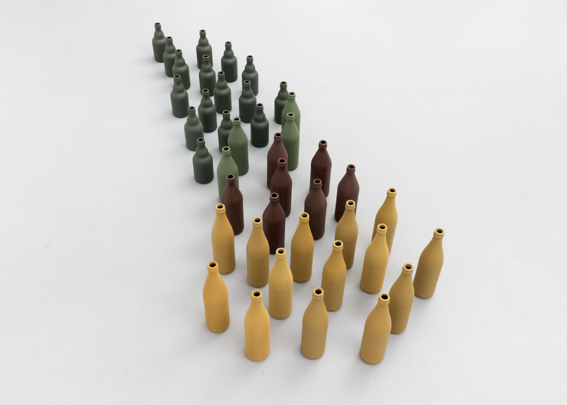 The pack (das Rudel), 2023. Paint on glass bottles, 170 × 75 × 26 cm (dimensions variable). From the series DIN – Standard parts in RAL colors.
