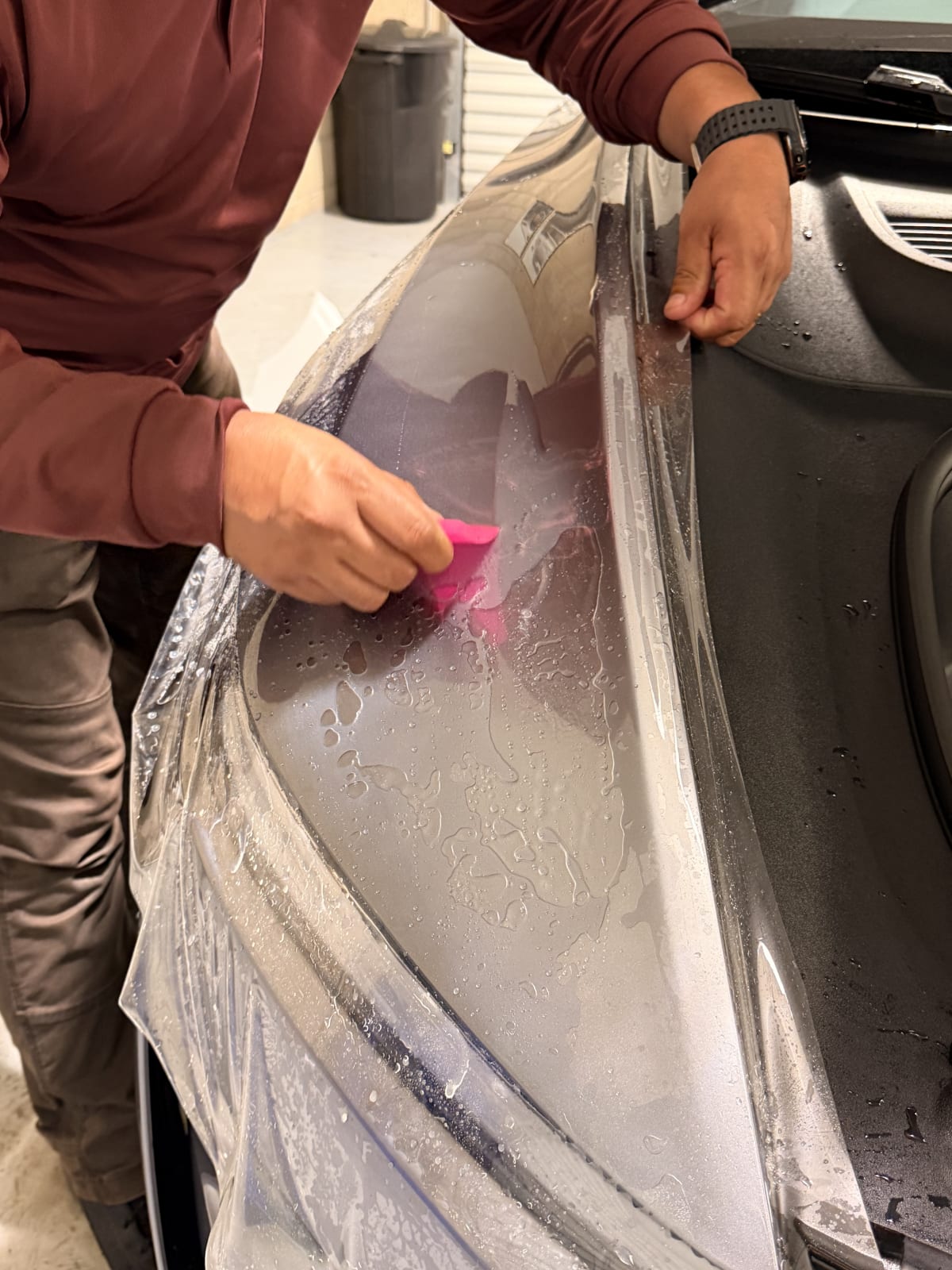 CDA Auto Styling technician installing paint protection film on a vehicle panel
