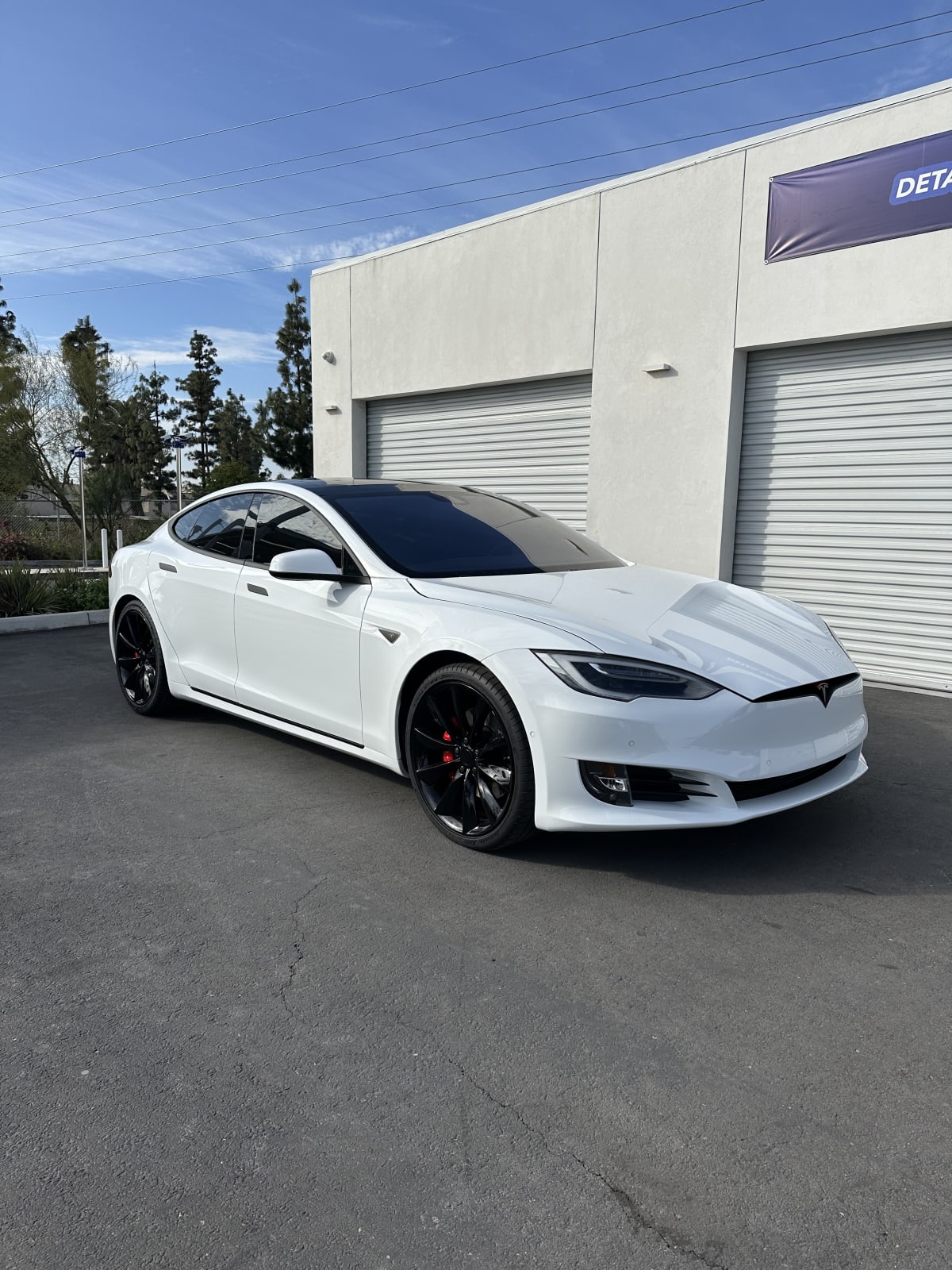 White Tesla outside CDA Auto Styling in the Inland Empire