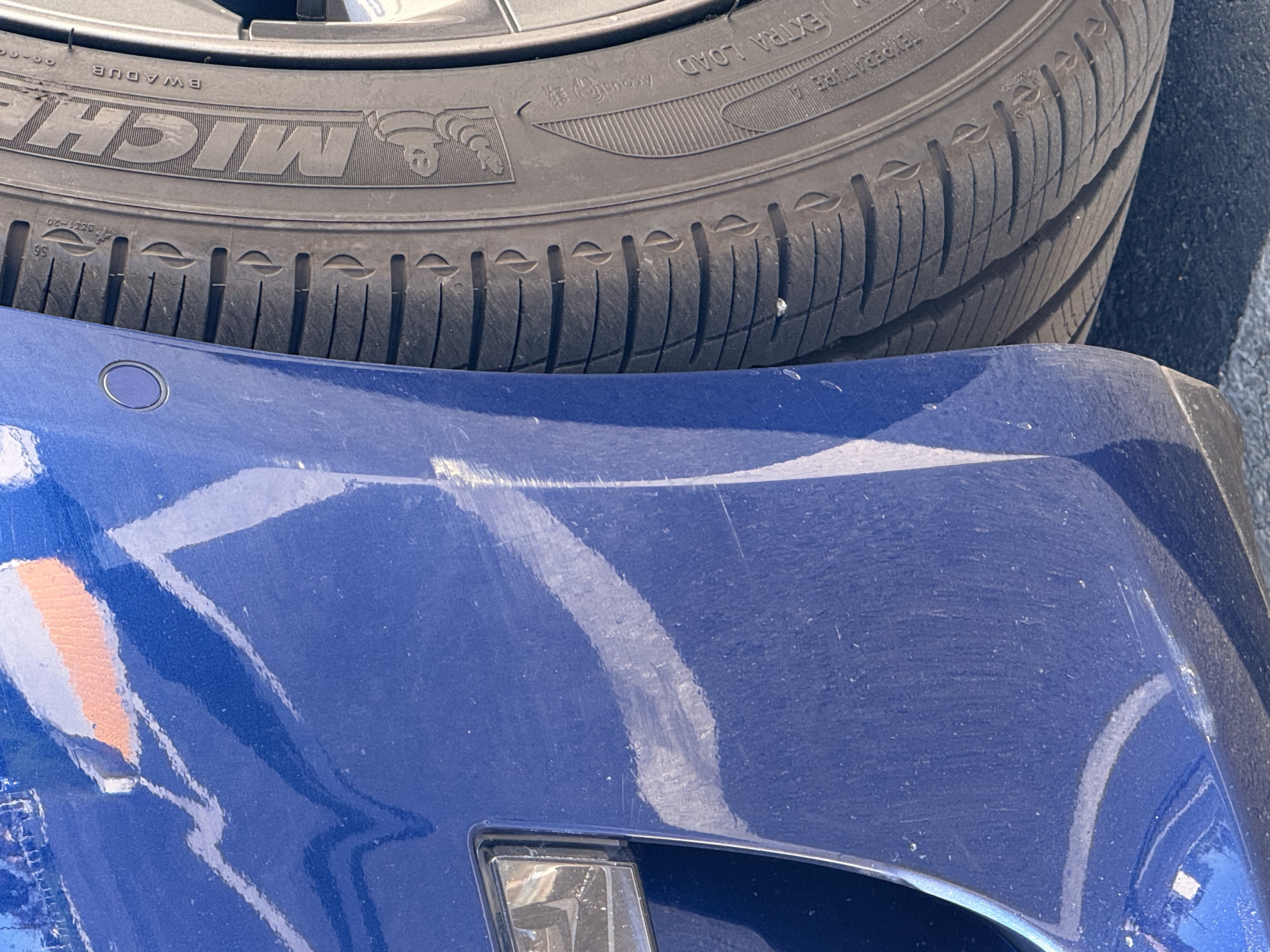 Tesla front end damage after freeway driving without PPF