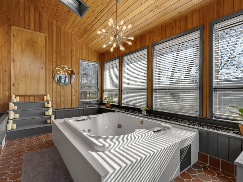 Blue Door Suite spa with jacuzzi and sputnik chandelier
