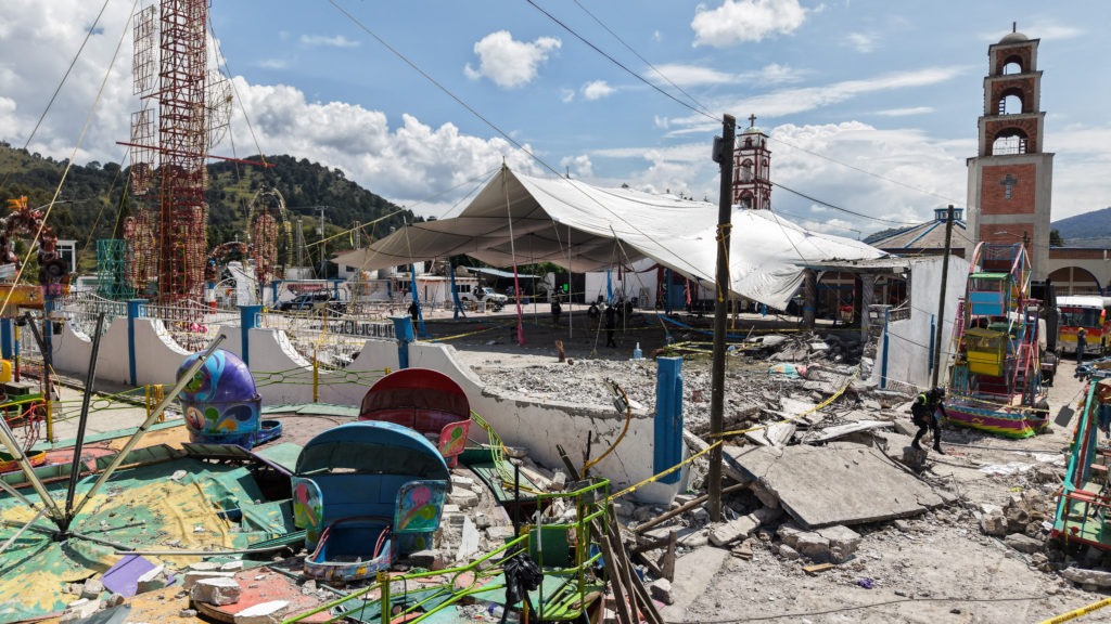 Emergency responders inspect debris after a fireworks explosion at a church festival in Temascalcingo, Mexico