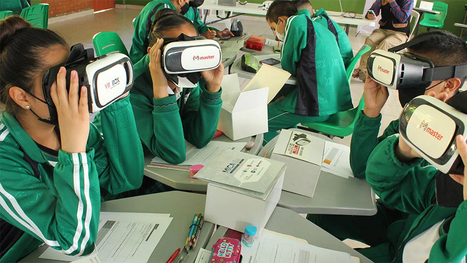 Students in Andean classrooms engage with digital STEM learning tools and science equipment.