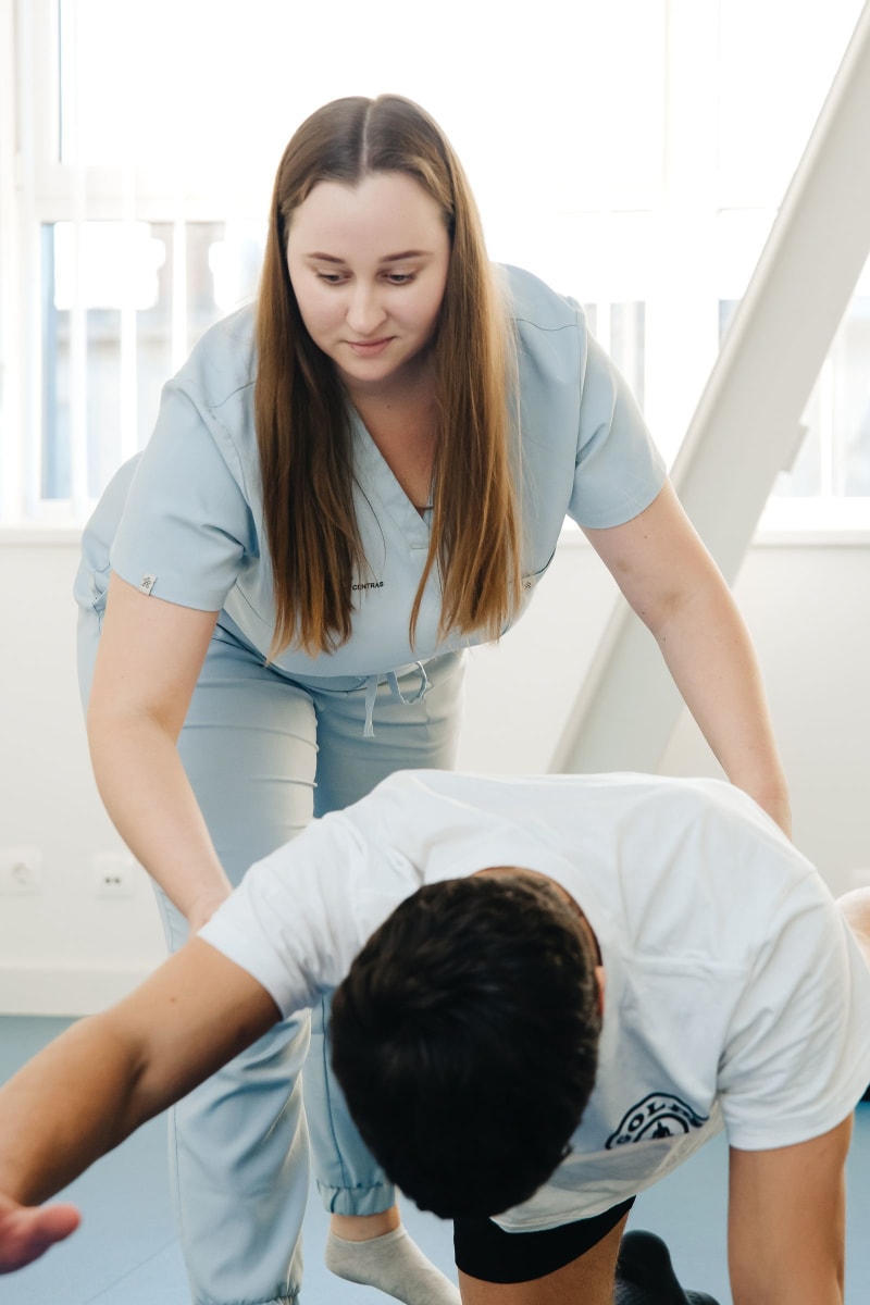Physiotherapist working with a patient in a professional studio
