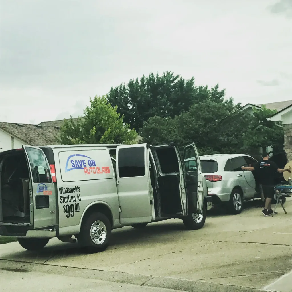 Van servicing vehicle in driveway.