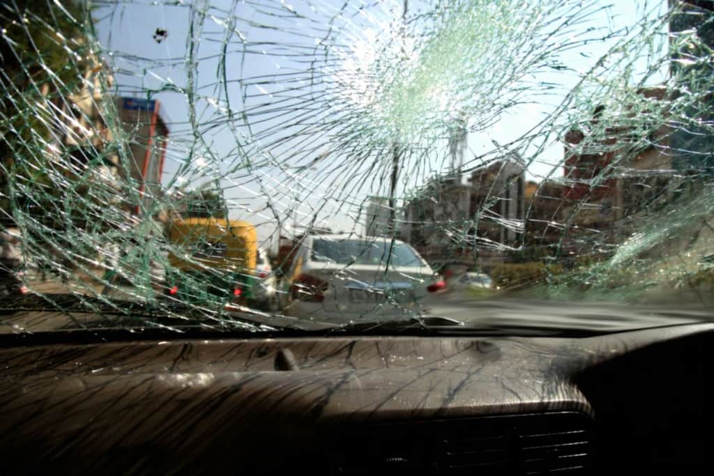 Inside of car with the broken windshield during road accident