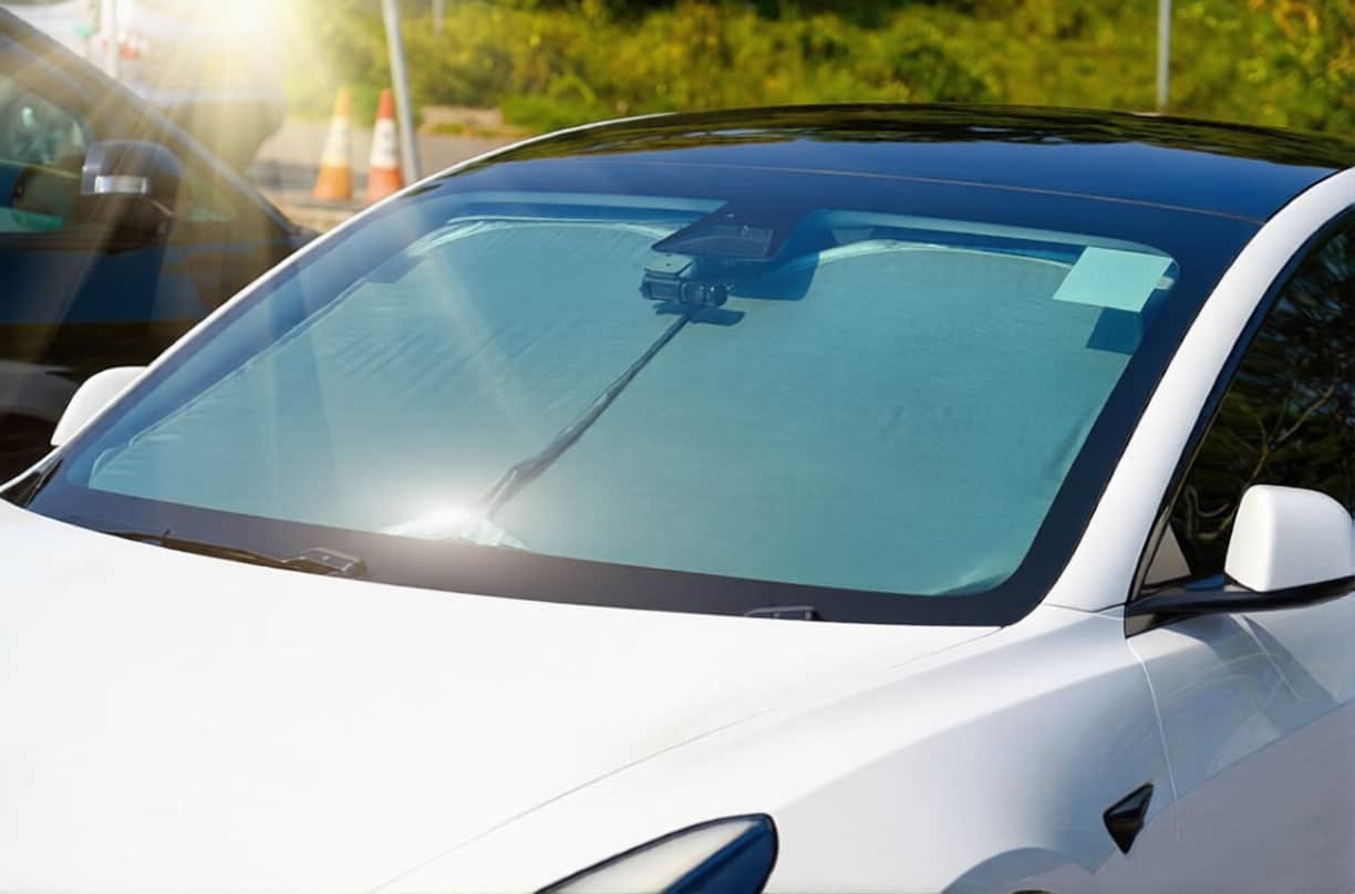 Protective reflective matte surface under the windshield of the passenger car parked on a hot day