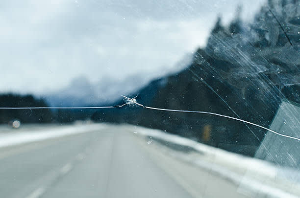 Cracked windshield close up on a highway